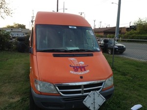 Water Damage Restoration Front Of Van At Dusk