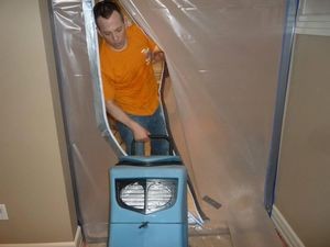 Water Damage Dixieland Technician Using Air Mover Near Vapor Barrier