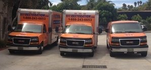 Water Damage Restoration Van And Trucks At Job Location